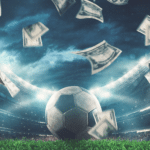 Geld wird um einen Fußball herumgewirbelt. © alphaspirit - stock.adobe.com